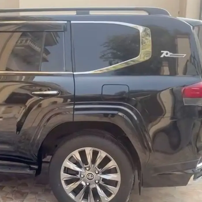 Side view of a black Land Cruiser available with driver in Lahore